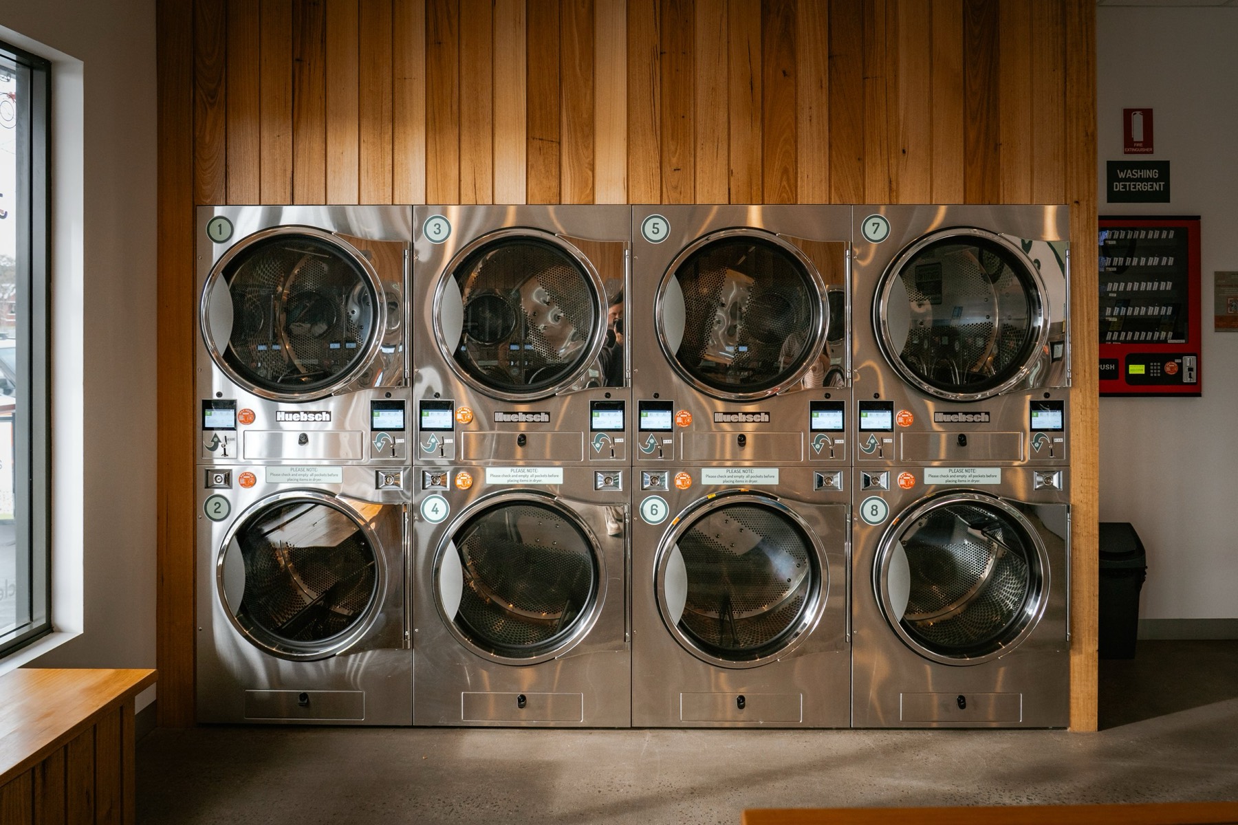 A wall of stacked Huebsch washers and dryers at Clear Laundromat Ballarat East